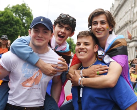 Four young men with rainbow flag