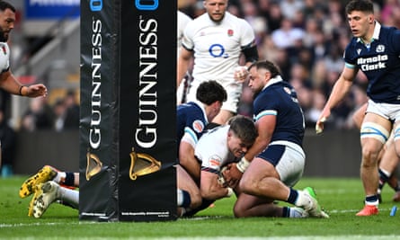 Tommy Freeman forces his way over the line for England’s try.