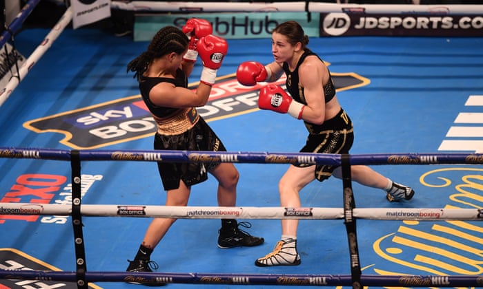 Katie Taylor (right) exchanges punches with Viviane Obenauf early in their bout.