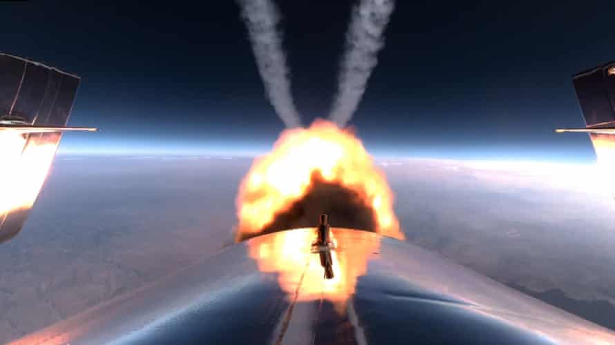 The rocket motor on Richard Branson’s Unity 22 burns as it heads toward space.