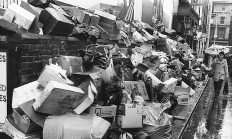 A woman passes a pavement piled high with rubbish during a dustman strike in 1979.