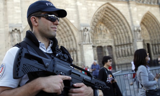 A French police officer patrols in front of Notre Dame cathedral, in Paris.