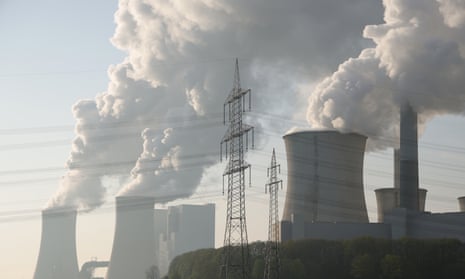 Steam rises from cooling towers at the Neurath coal-fired power plant in Germany. 