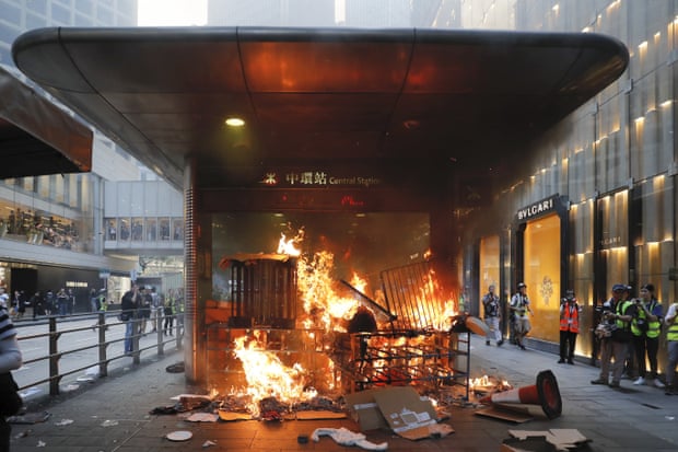 A fire set by protesters burns at an entrance to the Central MTR subway station in Hong Kong.