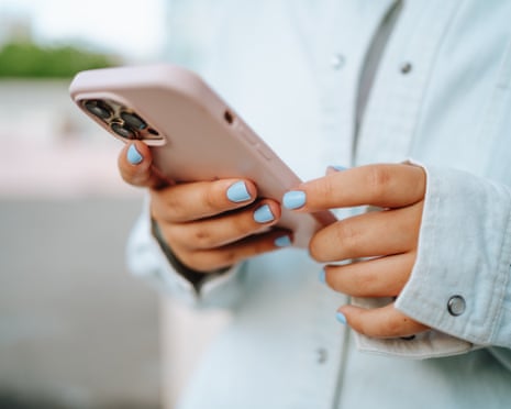 person's hands using phone