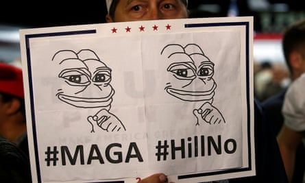 A Trump supporter holds a Pepe the Frog sign, a symbol that has become an emblem of the alt-right movement.
