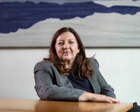 Kirsty McNeill, the minister of state for international development, sits at a table, resting her arm on it