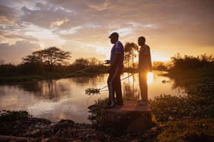 Nightclub doorman Erick Ochieng, left, and and mechanic Patrick Obondo try to catch fish to feed their families.