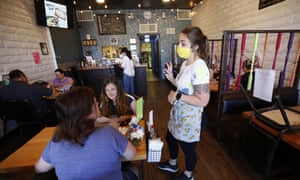 Server Jonnie Overmire goes over the menu for customers at the Lambert House Cafe in Yuba City.