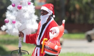 A Santa Claus sells Christmas decorations in Harare.