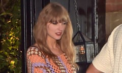 Taylor Swift and Travis Kelce (only his shirt showing)  in crochet ensembles.