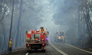 Firefighters make arrangements to secure the residential area from an approaching bushfire in Dargan, some 120 kilometres from Sydney