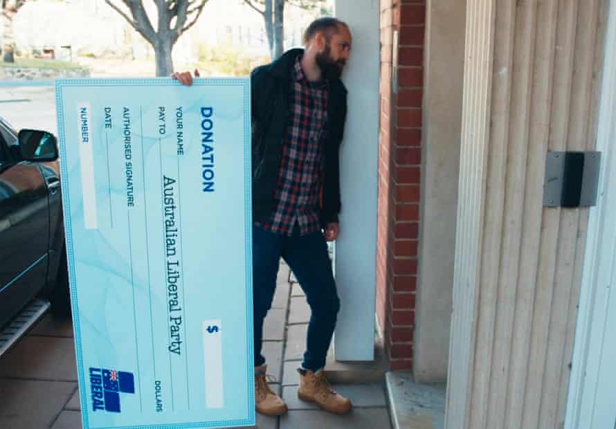 Christiaan Van Vuuren knocks on the door of the Liberal party with an oversized blank cheque.