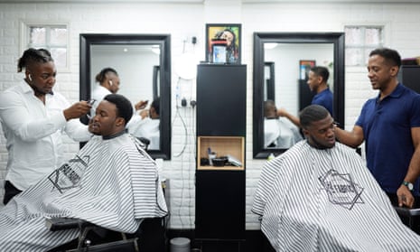 black barbers with two customers at Fade Fabric Barbers