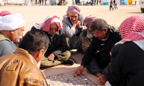 Yazidi refugees play chess at a refugee camp in Duhok