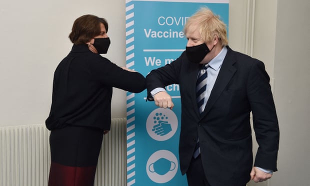 Boris Johnson (R) greets Northern Ireland First Minister Arlene Foster as they visit a Covid-19 vaccination centre  in Enniskillen, Northern Ireland