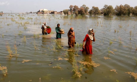 Women wade through floodwaters last year as they take refuge in Shikarpur district of Sindh province, Pakistan.