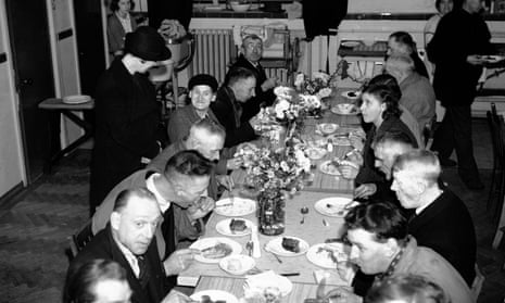 People sit down for a meal for sixpence in West Ham, London, 1940.