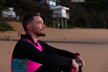 Graham Russell sits on the sandy beach
