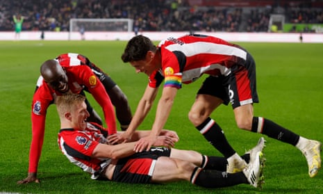Brentford's Ben Mee celebrates scoring their second goal with Christian Norgaard (right).