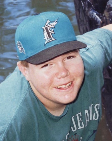 A young man wearing a baseball cap