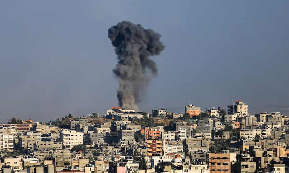 A plume of black smoke rises from a residential area. Gaza Strip, Palestinian Territory - 18 May 2021
