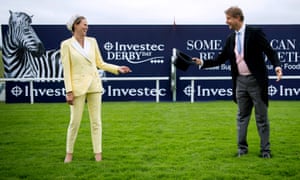ITV presenters Francesca Cumani (left) and Ed Chamberlin socially distancing out on the racecourse.