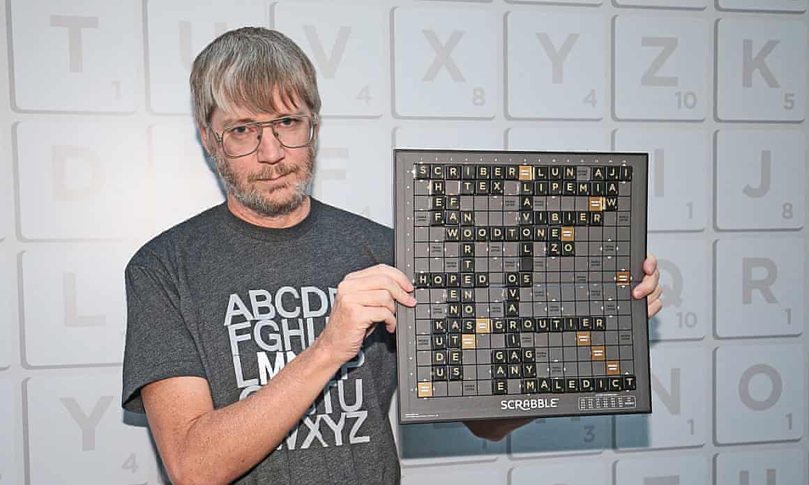 Nigel Richards holds up a Scrabble board