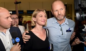 Australian 60 Minutes journalist Tara Brown (C) and 60 Minutes producer Stephen Rice arrive at Sydney International Airport, April 21, 2016.