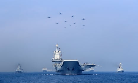 Warships and fighter jets of the Chinese People's Liberation Army (PLA) navy take part in a military display in the South China Sea.