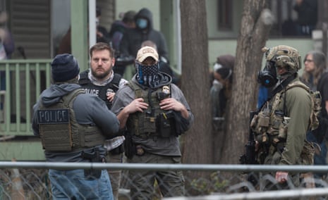 Federal immigration agents raid a home in St. PaulFederal officers from ICE and other agencies stand guard during an immigration raid of a home in St. Paul, Minnesota, U.S. November 25, 2025. REUTERS/Tim Evans