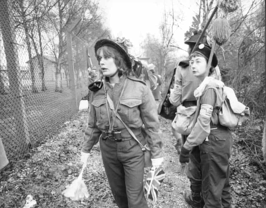 Women dressed as soldiers patrol the exterior fences in November 1982.