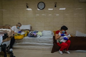 Nursing staff work round the clock to make sure all babies are fed and comforted in a makeshift nursery underground in the outskirts of Kyiv, Ukraine