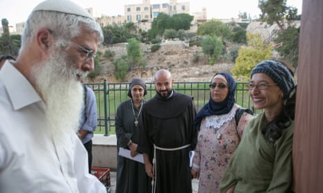 A member of the congregation is welcomed at the entrance of Amen by, right to left, Rabba Tamar Elad-Abblebaum, Waida Ibtisam Mahmeed, Father Alberto Fer and Sister Esther Salib