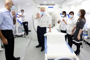 London, UKBritish Prime Minister Boris Johnson (C) gestures as he visits Finchley Memorial Hospital. Johnson “categorically” rejected claims by his former chief aide that he lied to parliament last week about a Downing Street party held during a strict lockdown
