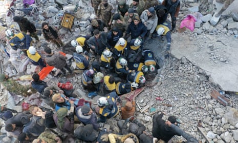 An aerial picture shows rescuers searching the rubble of buildings for casualties and survivors in the village of Besnaya in Syria's rebel-held northwestern Idlib province.