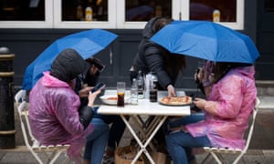 People in Cardiff City centre on Bank Holiday Monday as the rain came down and temperatures plummeted.