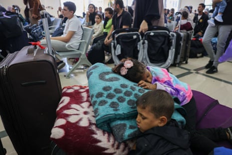 Children sleep as they wait to cross the border between Gaza and Egypt.