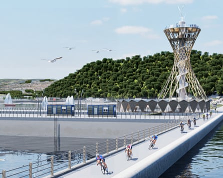 Cyclists race over a narrow concrete track cutting through water in front of a conical viewing tower, seagulls, yachts and a wooded hillside