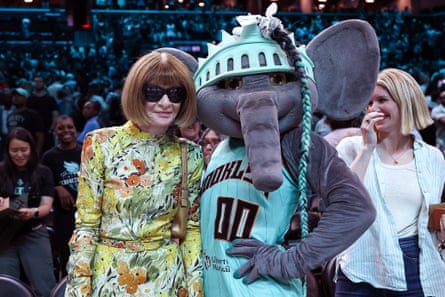 Anna Wintour poses for a photo with New York Liberty mascot Ellie the Elephant after the game between the New York Liberty and the Seattle Storm at Barclays Center on 5 August in Brooklyn, New York
