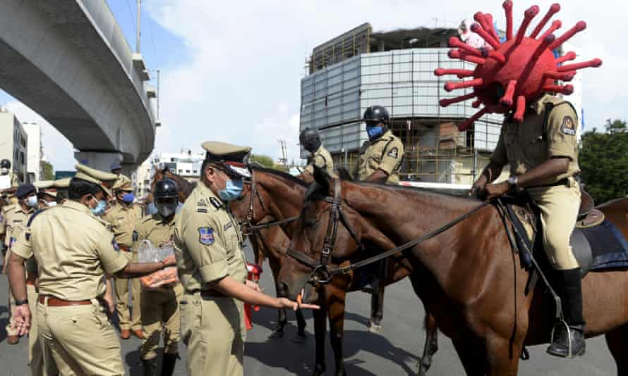 A police personnel wearing a Covid-19 coronavirus-themed helmet sits on his horse as he takes part in an awareness campaign at a traffic junction in Hyderabad, India.