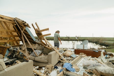 The photo shows Kip de’Laune searching for any salvageable items at his home in Point-Aux-Chenes after Hurricane Ida.