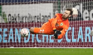 Burnley goalkeeper Will Norris makes a save from Milton Keynes Dons’ Lasse Sorensen in the penalty shootout