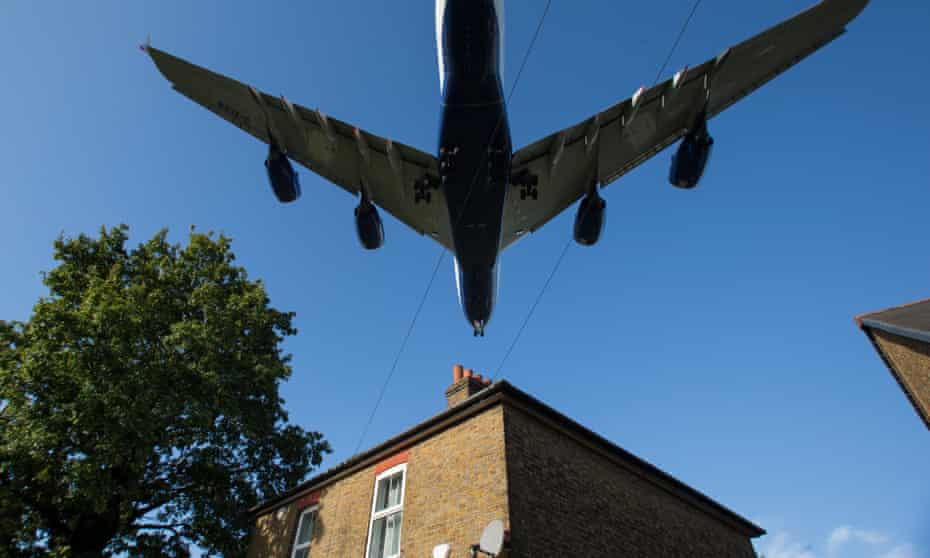A plane flying over a house in west London