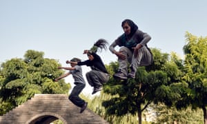 Iranian women practice parkour skills at a park in Tehran.