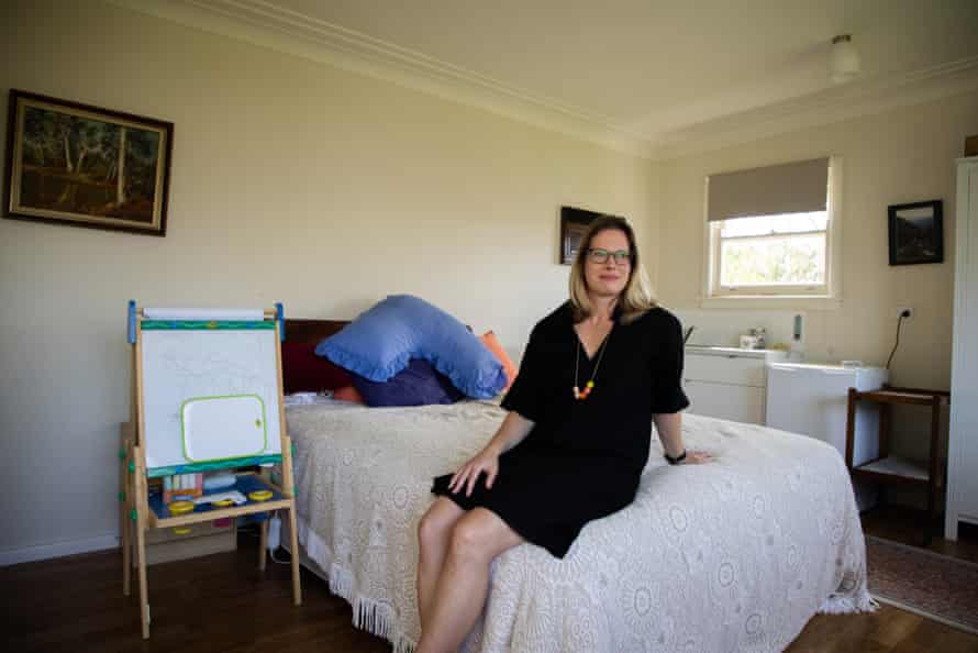 Jacqui Housden sitting in the granny flat at her childhood home.