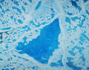 A large pool of melt water over ice on top of the Beaufort Sea in the Arctic Ocean. 
