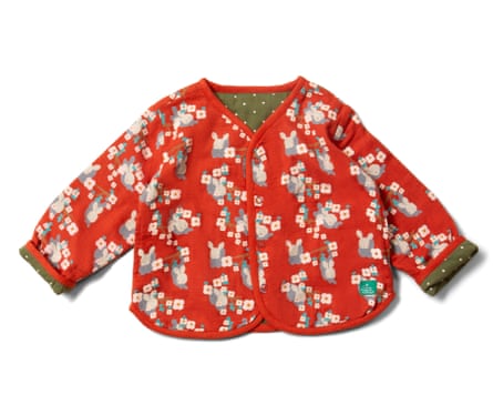 A red kids’ jacket with a rabbit and flower print