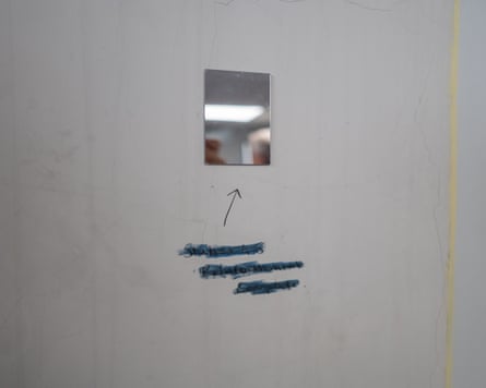 A small mirror stuck to the wall with an arrow and a handwritten note underneath that says ‘station 48 refurbishment complete’