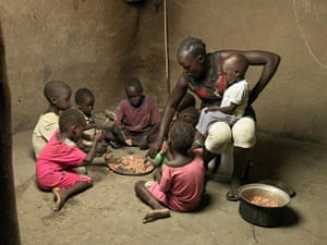 Kulang feeds rice to her baby, Goy, and other children in the village